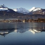 The Salzkammergut mountain range reflect in the peaceful lake